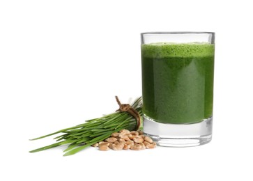 Glass of fresh wheat grass juice, seeds and sprouts on white background