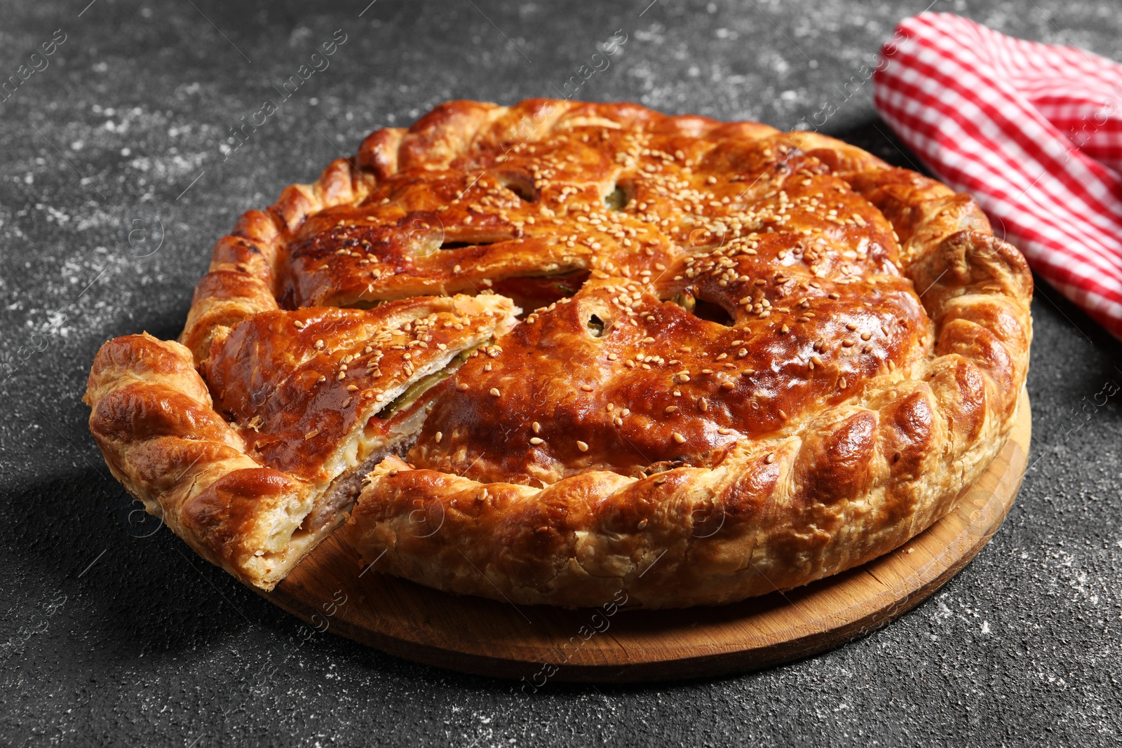 Photo of Cut delicious homemade pie on black table