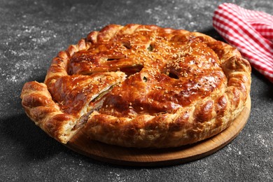 Photo of Cut delicious homemade pie on black table