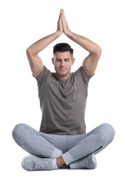 Photo of Handsome man meditating on white background. Harmony and zen