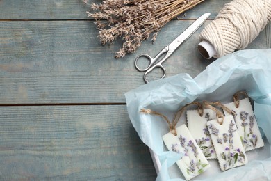 Photo of Flat lay composition with scented sachets on blue wooden table, space for text