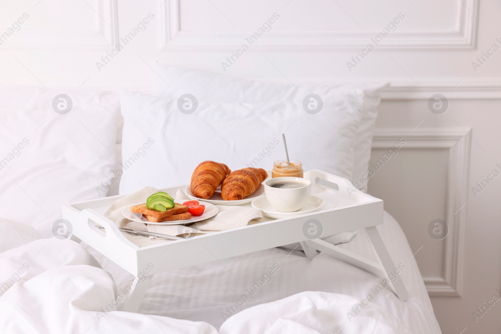 Good morning. Tray with tasty breakfast on bed at home Photo of Good morning. Tray with tasty breakfast on bed at home