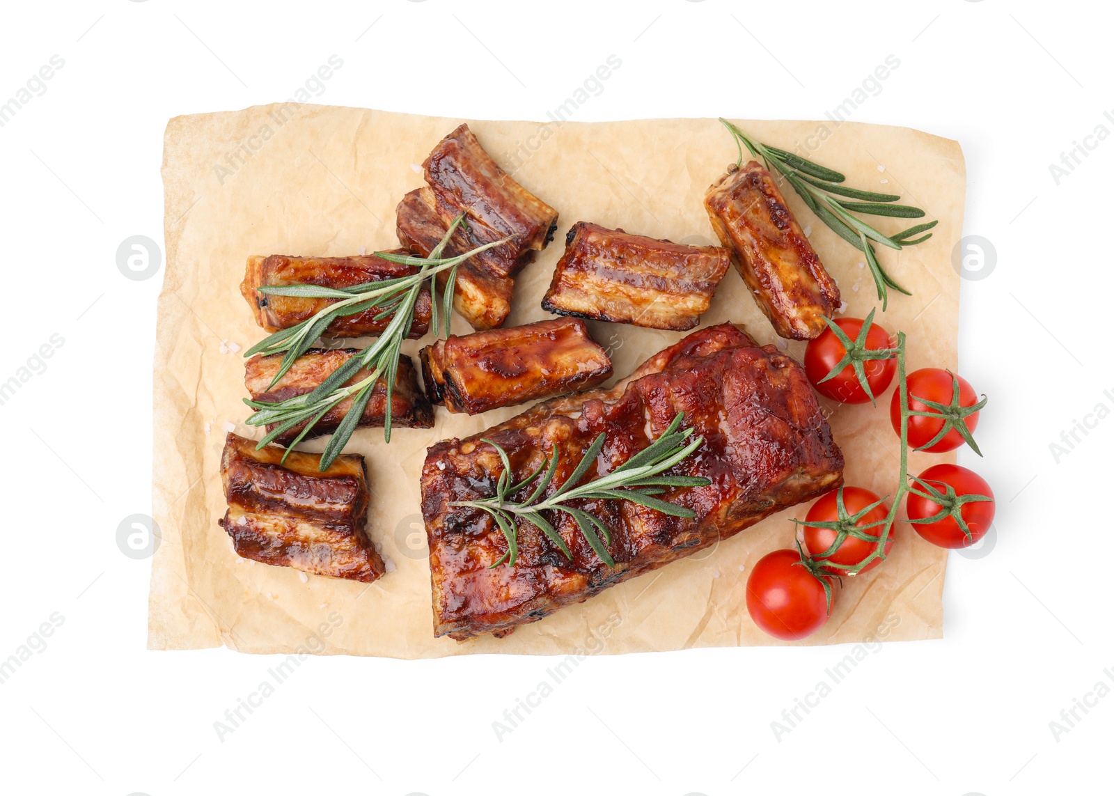 Photo of Tasty roasted pork ribs, rosemary and tomatoes isolated on white, top view