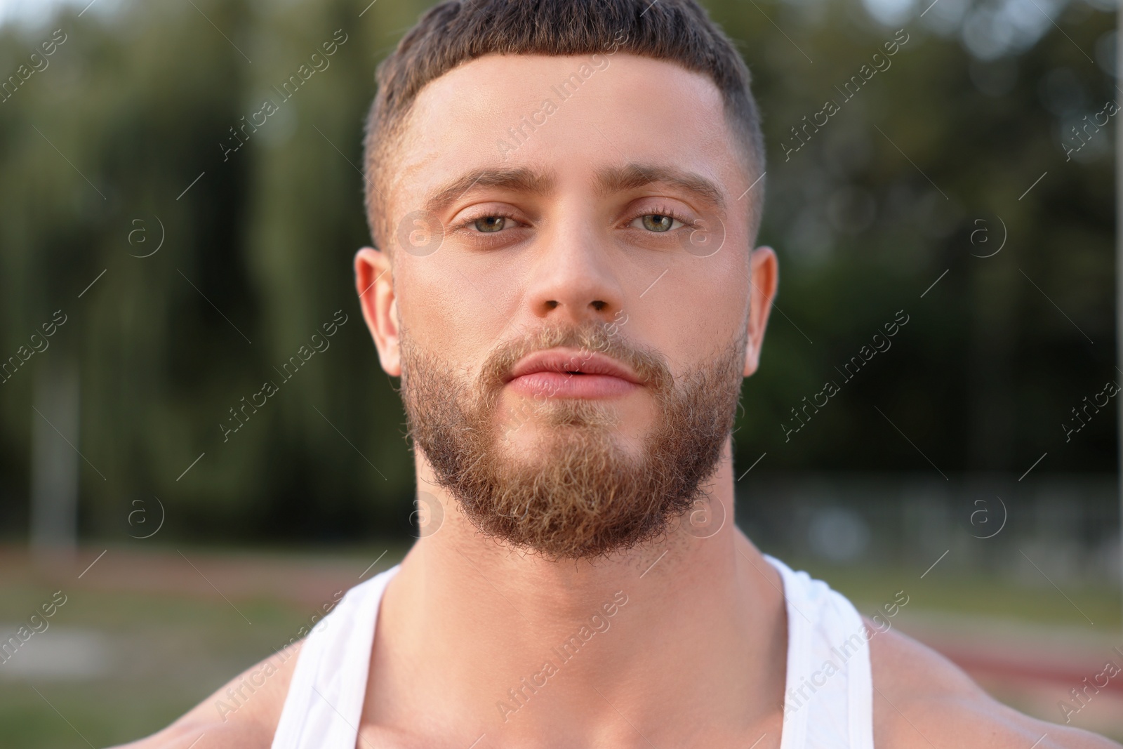 Photo of Portrait of attractive young man outdoors on summer day