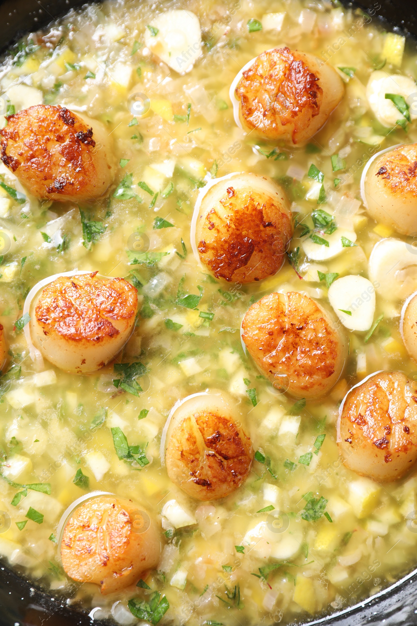 Photo of Fried scallops with sauce in dish, top view