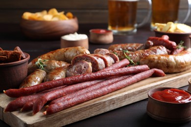 Set of different tasty snacks on wooden table, closeup view