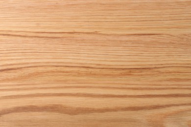 Photo of Texture of wooden cutting board as background, top view