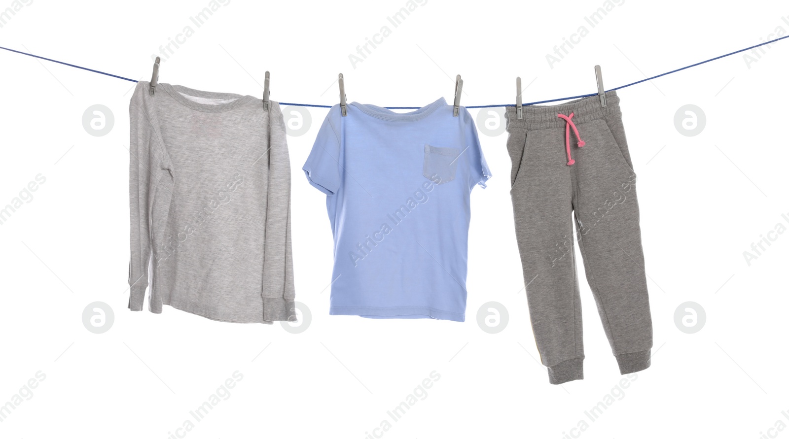 Photo of Different clothes drying on washing line against white background