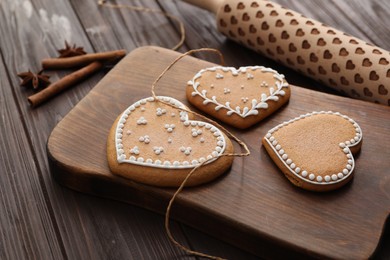 Delicious heart shaped Christmas cookies on wooden table