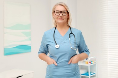 Photo of Portrait of professional doctor wearing uniform in clinic