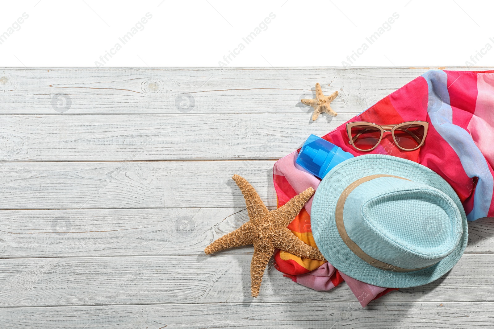 Photo of Flat lay composition with beach accessories on wooden background. Space for text