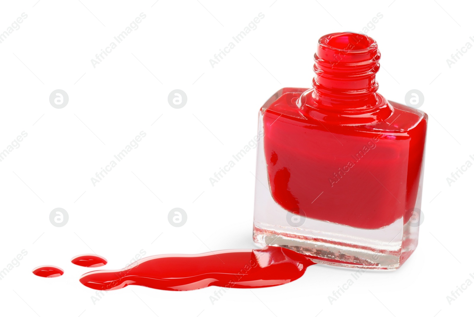 Photo of Bottle and spilled red nail polish isolated on white