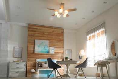 Stylish room interior with modern ceiling fan, low angle view