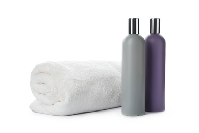 Rolled towel and shampoo isolated on white