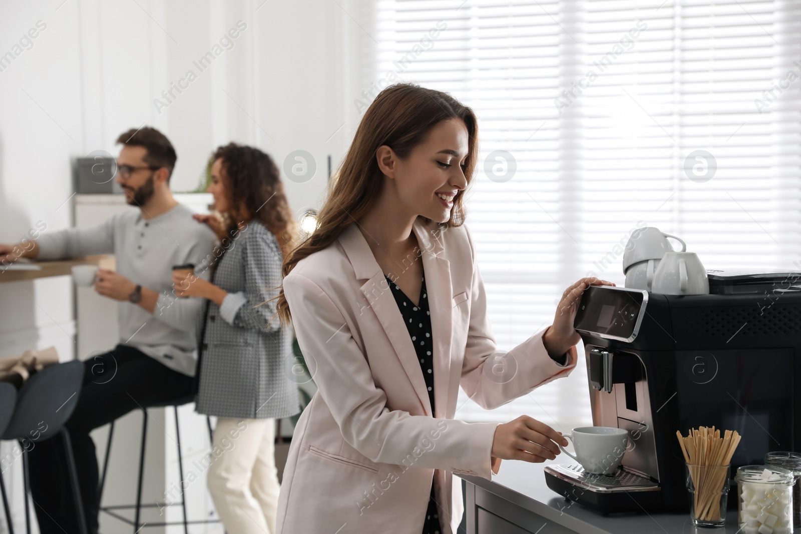 Photo of Woman preparing fresh aromatic coffee with modern machine in office
