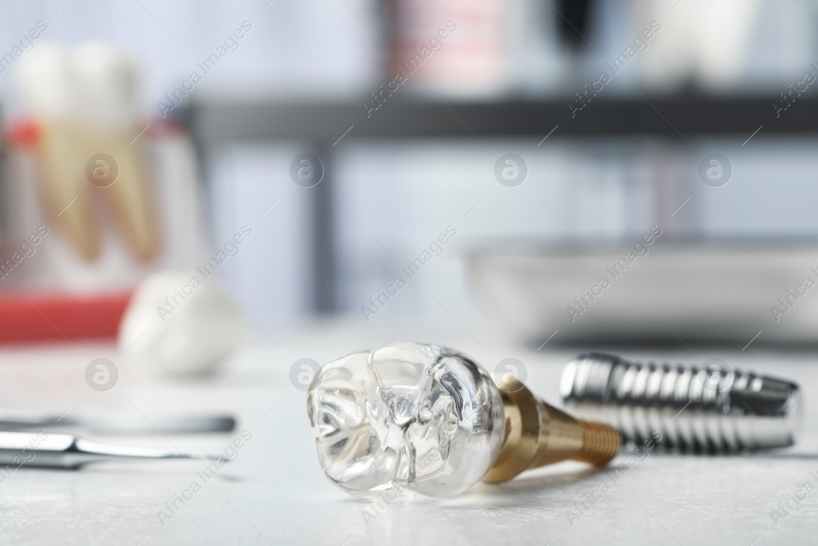 Photo of Parts of dental implant on light table indoors, closeup. Space for text