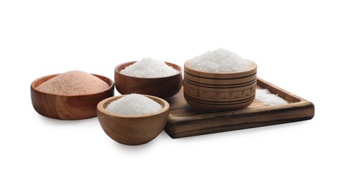 Photo of Different types of natural salt in wooden bowls isolated on white