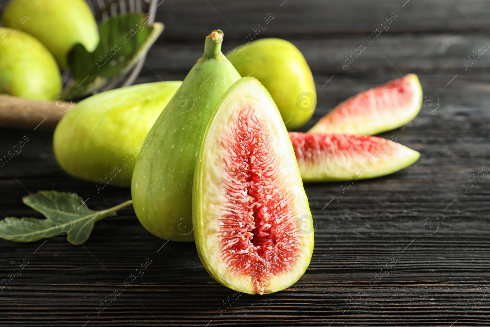 Photo of Fresh ripe figs on wooden table. Tropical fruit