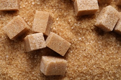 Photo of Different types of brown sugar as background, top view