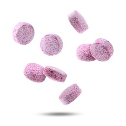 Image of Vitamin. Pink tablets falling on white background