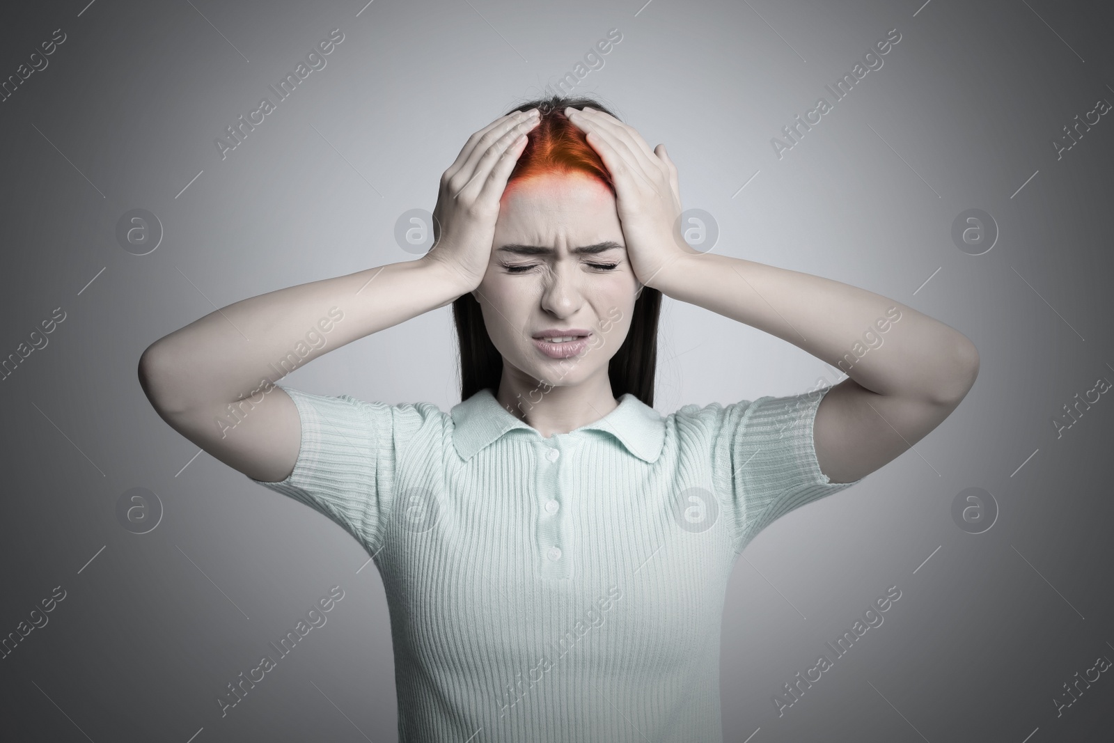 Image of Young woman having headache on light grey background