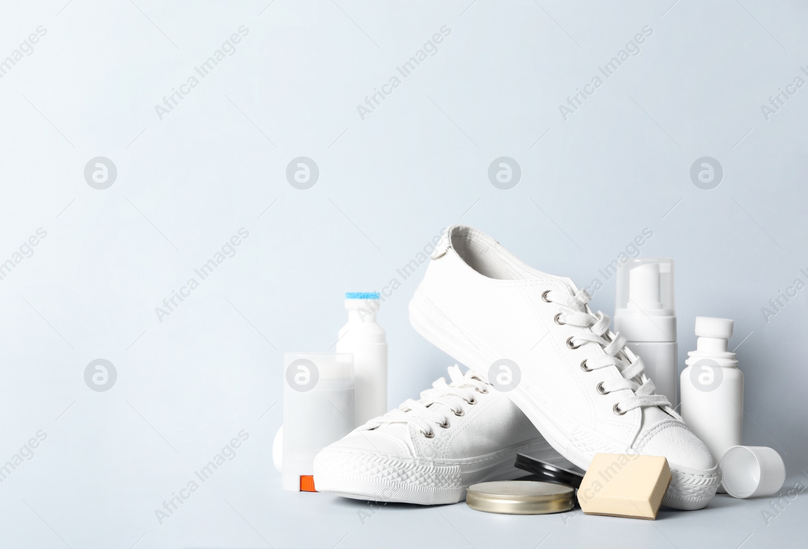 Photo of Composition with stylish footwear and shoe care accessories on white background