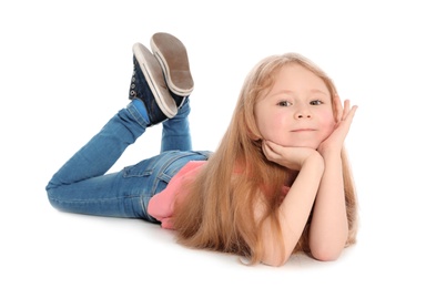 Photo of Cute little girl in casual outfit lying on white background