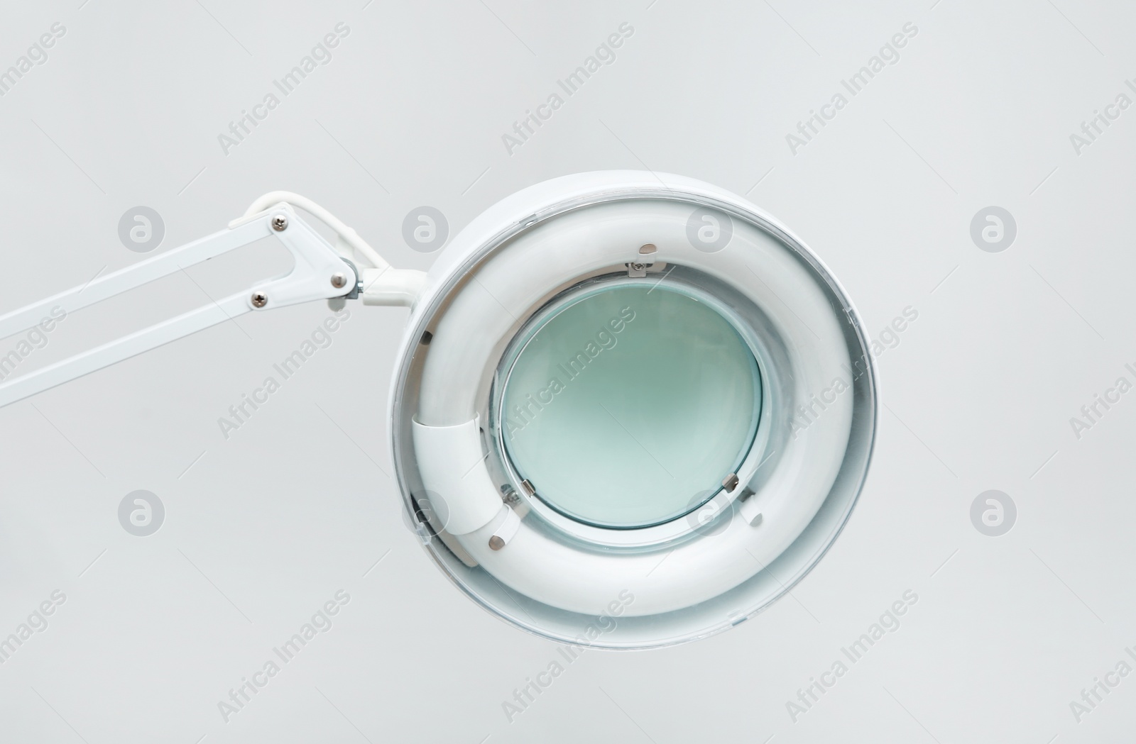 Photo of Medical lamp with magnifying glass in modern clinic