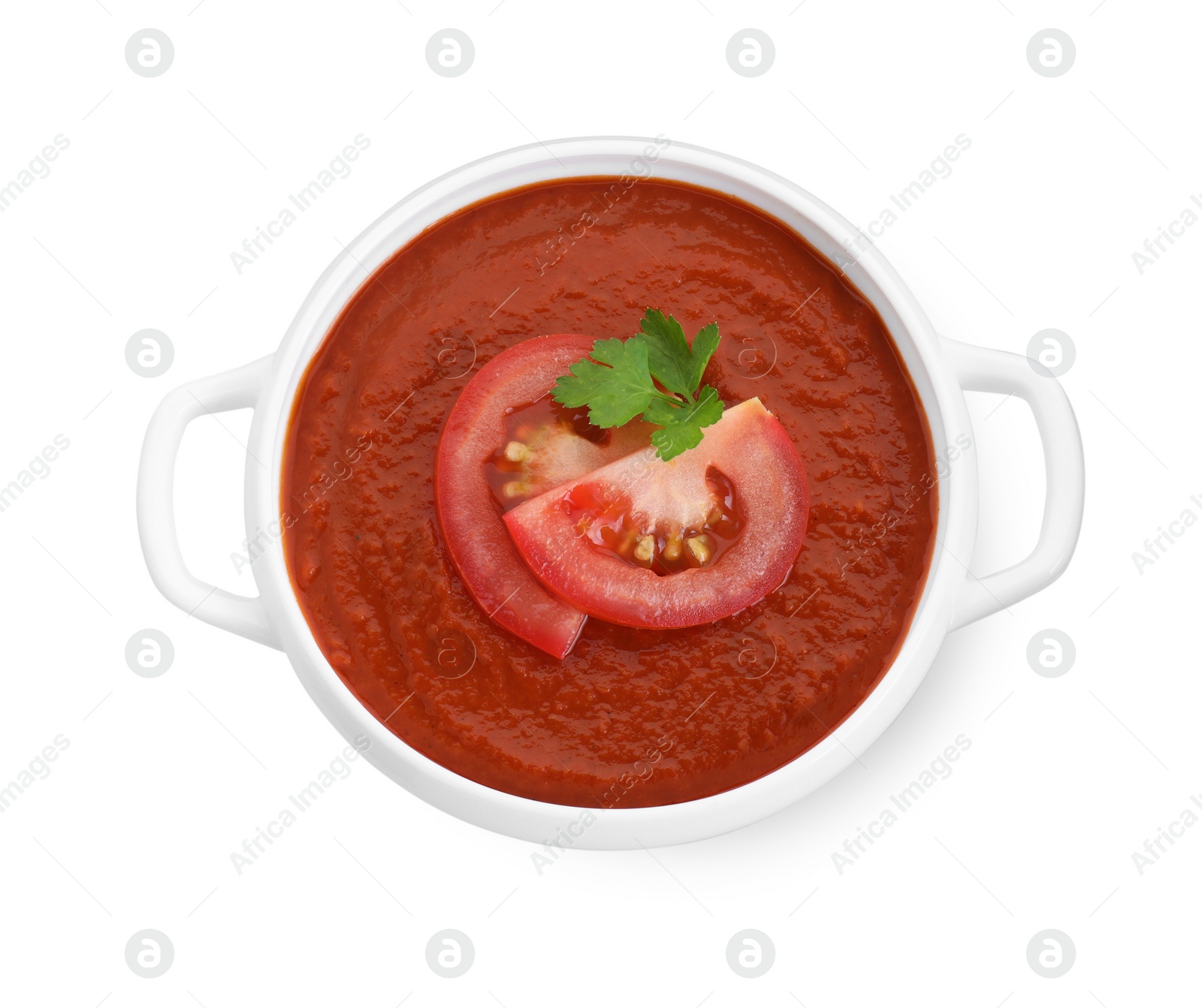 Photo of Delicious tomato cream soup in bowl isolated on white, top view