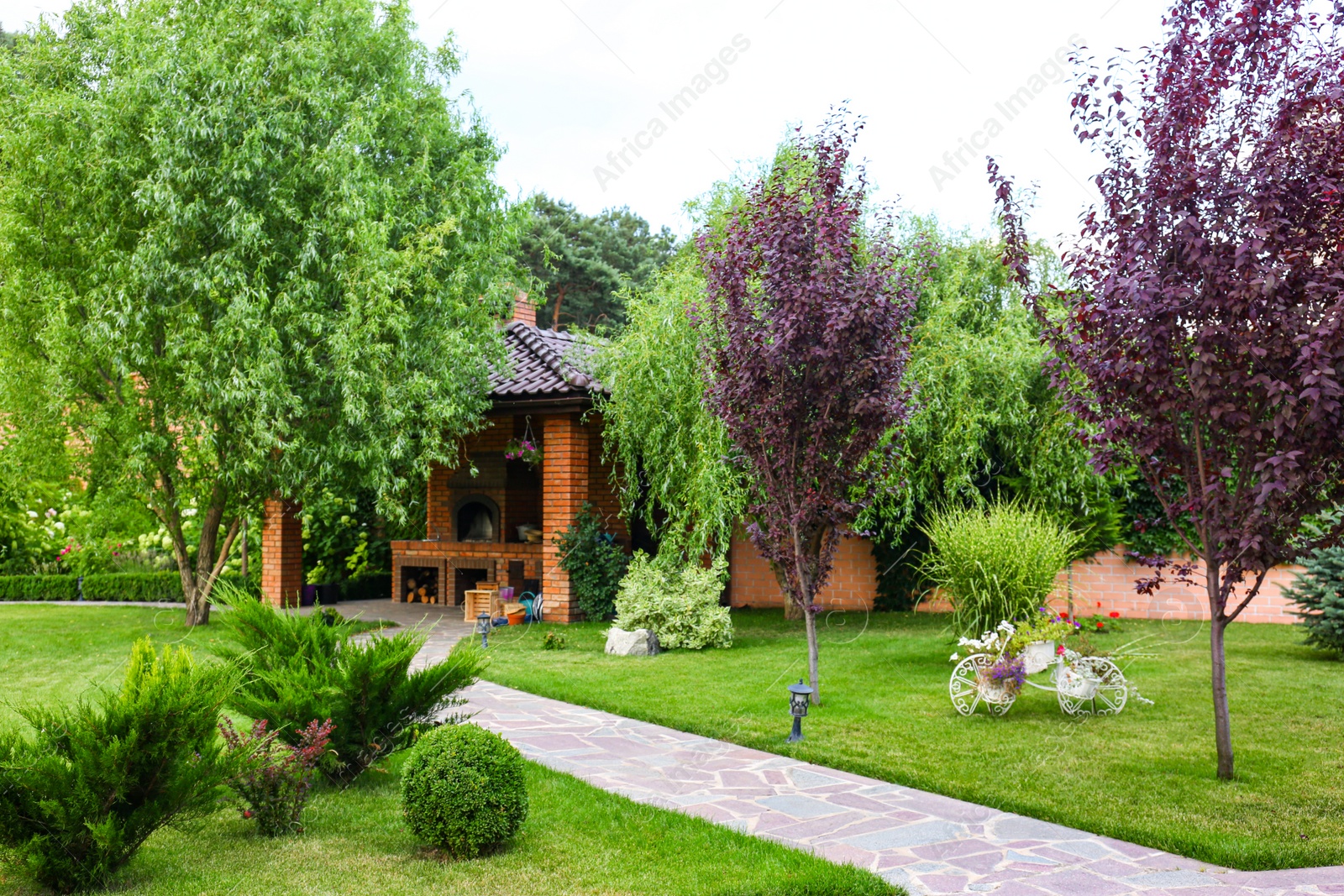 Photo of Landscape with beautiful green garden and gazebo on summer day