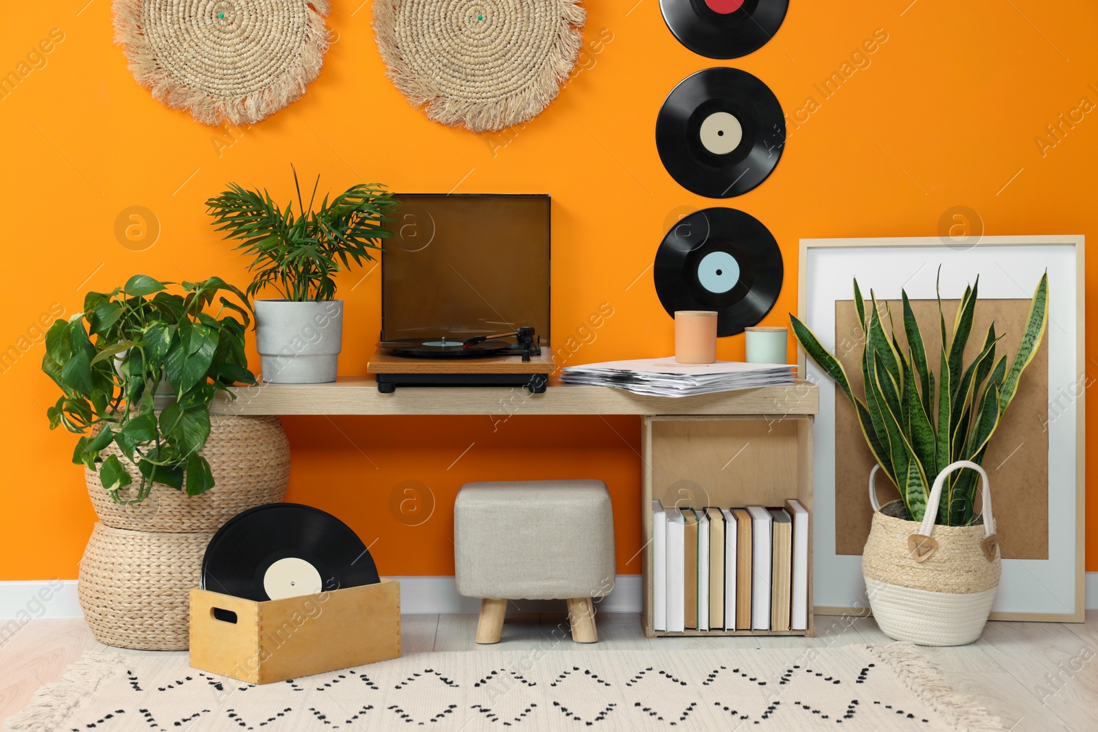 Photo of Stylish turntable with vinyl record on console table in cozy room