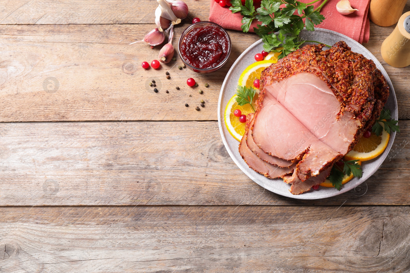 Photo of Delicious homemade ham on wooden  table, space for text. Festive dinner