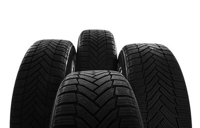 Photo of Set of wheels with winter tires on white background, closeup