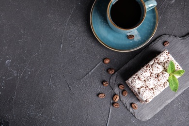 Flat lay composition with tiramisu cake and coffee on grey table, space for text