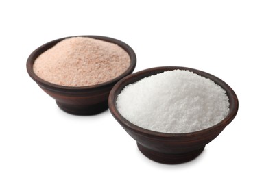 Photo of Different types of natural salt in bowls isolated on white