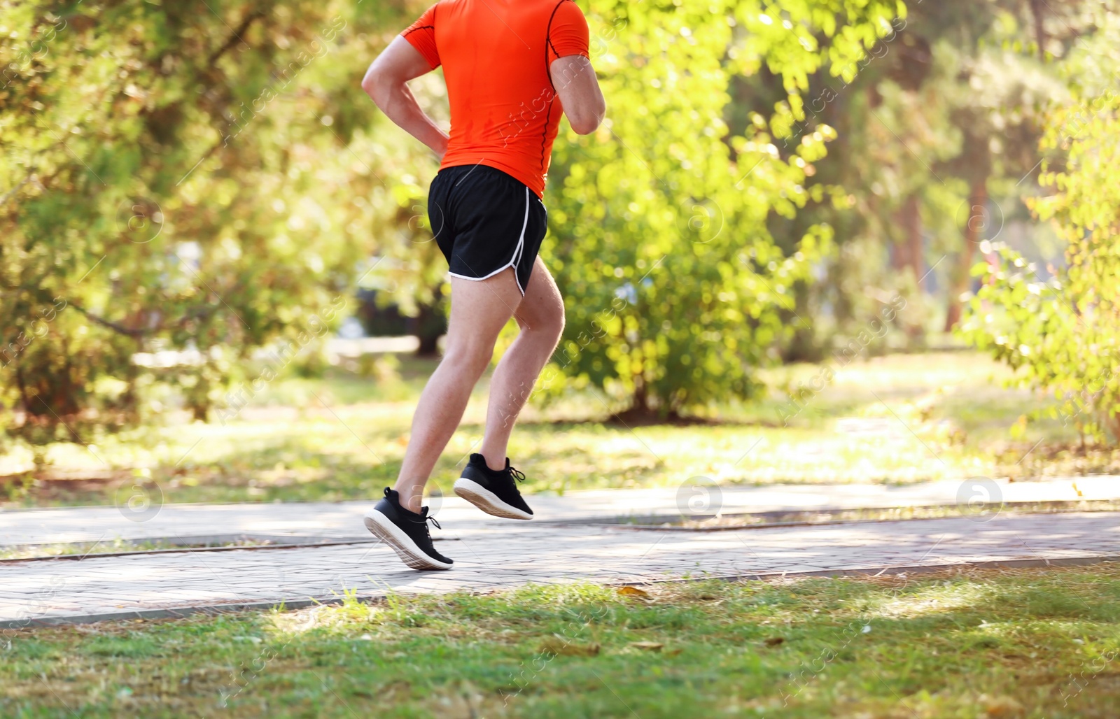 Photo of Young man running in park on sunny day