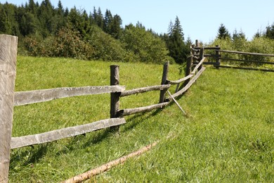 Photo of Beautiful view of mountain countryside with wooden fence