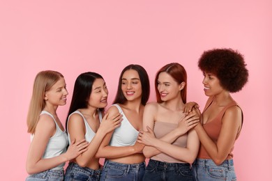 Photo of Portrait of beautiful young women on pink background