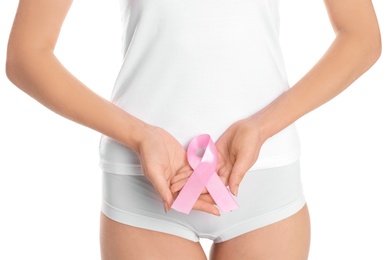 Photo of Young woman with pink ribbon on white background. Gynecology