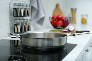 Empty frying pan on induction stove in kitchen