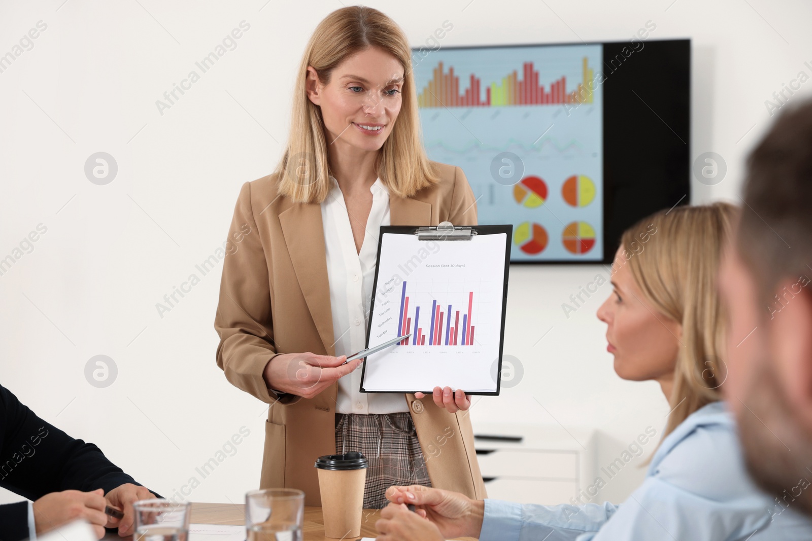 Photo of Businesswoman showing chart on meeting in office