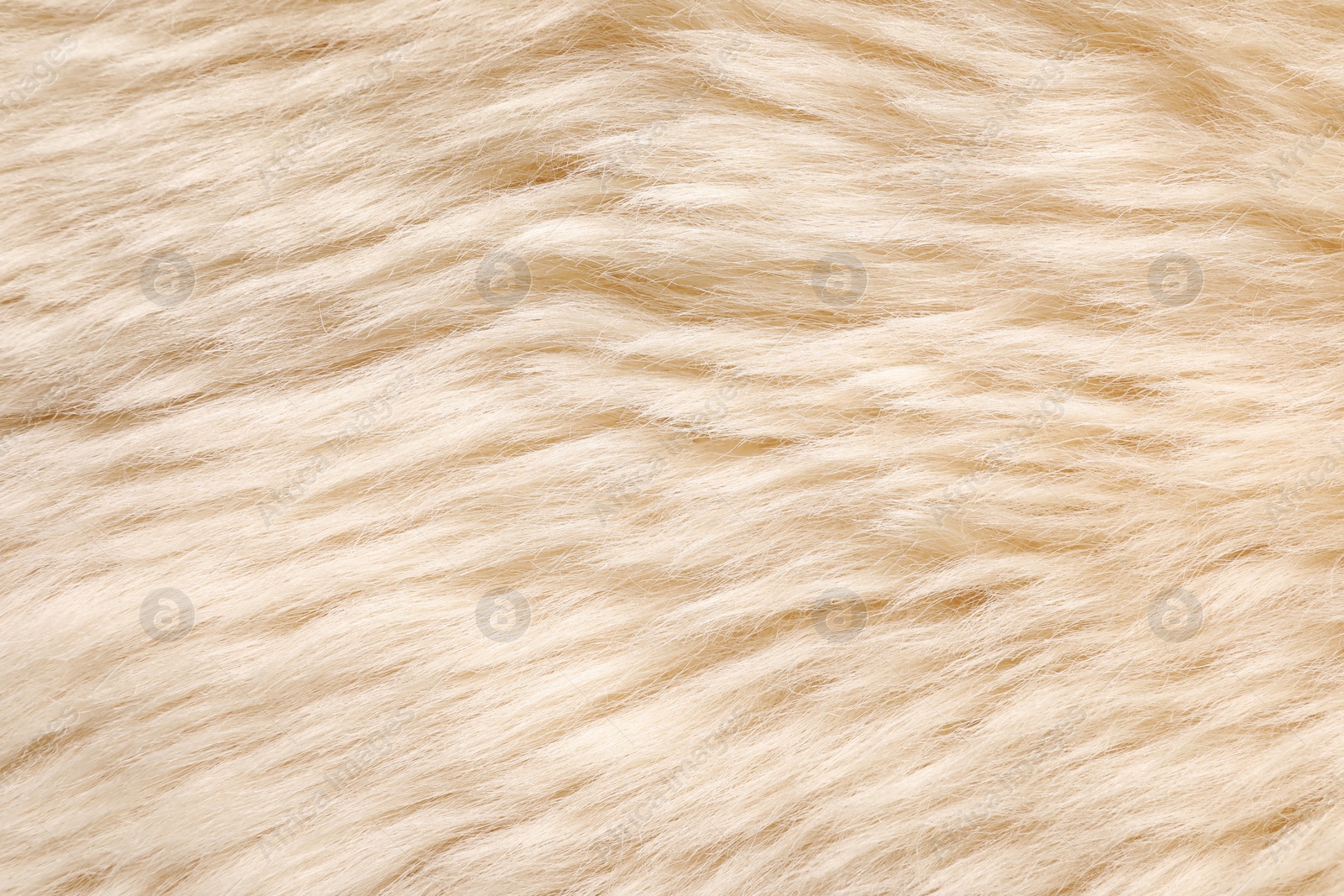 Photo of Texture of beige faux fur as background, top view