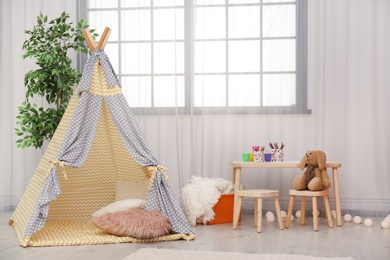 Modern nursery room interior with play tent for kids