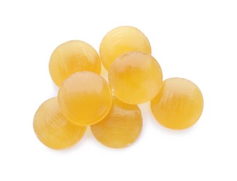 Photo of Many yellow cough drops on white background, top view