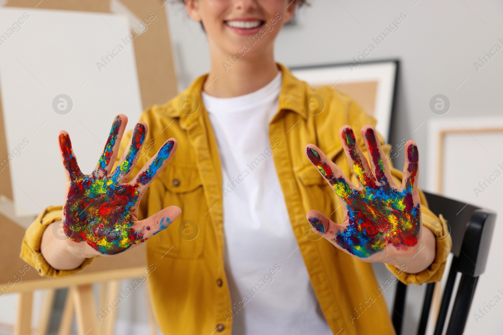 Photo of Woman with painted palms indoors, closeup view