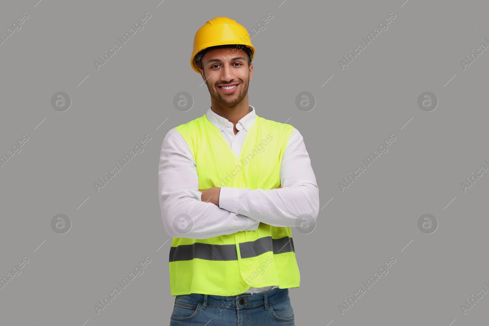 Photo of Engineer in hard hat on grey background