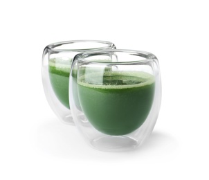Photo of Fresh wheat grass juice in glasses on white background