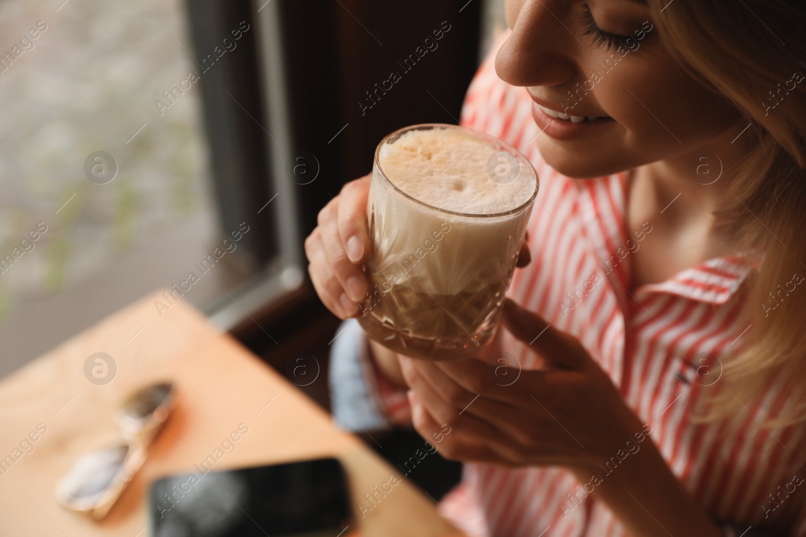 Photo of Young woman with glass of coffee in morning, closeup. Space for text