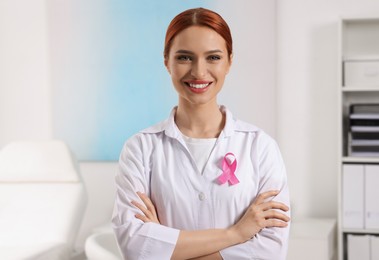 Mammologist with pink ribbon in hospital. Breast cancer awareness