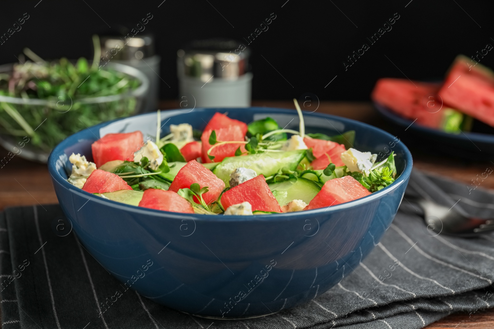 Photo of Delicious salad with watermelon served in bowl, closeup